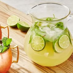 three pitchers filled with different kinds of drinks