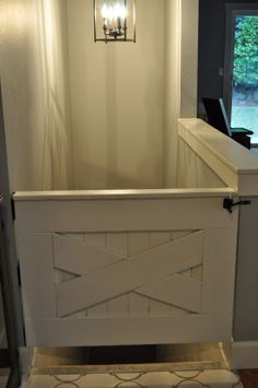 a bathroom with a white fence and light fixture