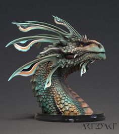 a statue of a green dragon on a black base