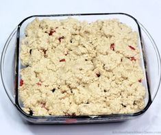 a casserole dish filled with crumbs on top of a white table