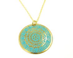 Turquoise and gold medallion necklace features a round gold disc embossed with an ornate design and colored with turquoise enamel. Pendant is 1 3/16 inches in diameter (30mm). Your choice of chain lengths - 18 or 20 inches. Find more necklace styles here - https://www.etsy.com/shop/CharleneSevier?ref=hdr_shop_menu&section_id=10084290 Blue Coin Pendant Jewelry, Bohemian Gold Necklace With Patina, Blue Medallion Necklace With Coin Pendant, Turquoise Engraved Round Pendant Necklace, Bohemian Engraved Turquoise Necklaces, Bohemian Yellow Gold Medallion Necklaces, Engraved Turquoise Necklace With Round Pendant, Bohemian Yellow Gold Medallion Necklace, Yellow Gold Bohemian Medallion Necklace