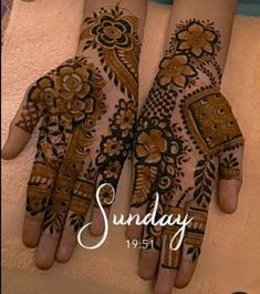 two hands with henna designs on them and the words sunday written in white ink