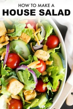 a salad with lettuce, tomatoes and croutons is shown in a bowl