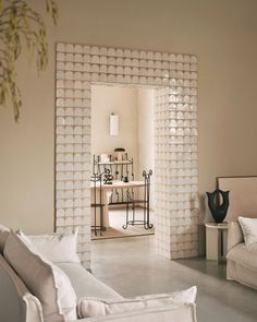 a living room filled with furniture and decor on top of a white tile flooring