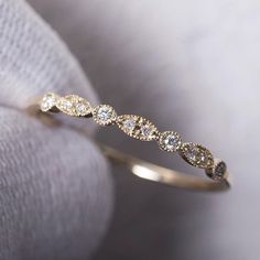 a diamond ring sitting on top of a white cloth