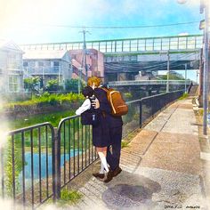 a man with a backpack is walking down the street near a bridge and water way