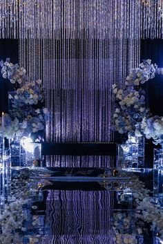 an elaborately decorated room with flowers and chandelier hanging from the ceiling in front of it