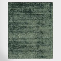 a green area rug with an abstract design