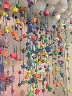 colorful stars and balls hanging from the ceiling