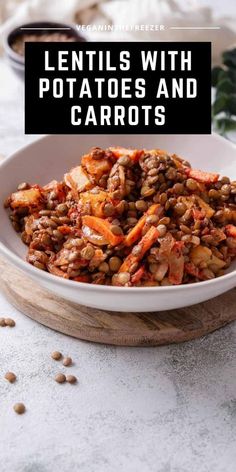 lentils with potatoes and carrots in a white bowl on a wooden cutting board