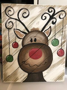 a painting of a reindeer with ornaments hanging from it's antlers and nose