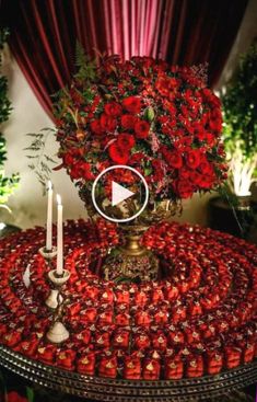 a table topped with red roses and candles