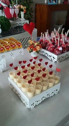 desserts and candies displayed on a table at a valentine's day party