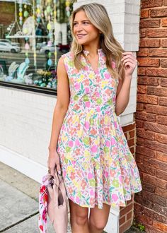 This Pastel Floral Vneck Dress is perfect for springtime. With a beautiful pastel floral print and a fun v-neck, this dress will instantly upgrade your look. It is fully lined for comfort and it's sure to be a go-to staple in your wardrobe. True to size Olivia is wearing small If between sizes or busty, size up V Neckline with faux button detail Ruffle detail at neckline and bottom hem Sleeveless - but bra friendly Zippered back closure Lined Side Pockets Fabric content: 100% Cotton Fabric has n Ditsy Floral Print V-neck Dress For Garden Party, Pink Floral Print V-neck Dress For Summer, Floral Print V-neck Dress For Summer Brunch, Floral Print Sundress V-neck For Day Out, Pink V-neck Mini Dress For Spring, Pink Feminine V-neck Dress For Vacation, Feminine Pink V-neck Dress For Vacation, Spring Floral Print V-neck Dress For Vacation, Spring V-neck Floral Dress For Brunch