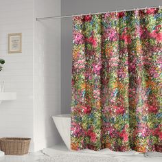 a colorful shower curtain in a white bathroom