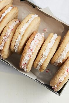 a box filled with lots of cookies covered in frosting