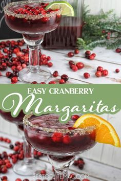 two glasses filled with cranberry margaritas and garnished with orange slices