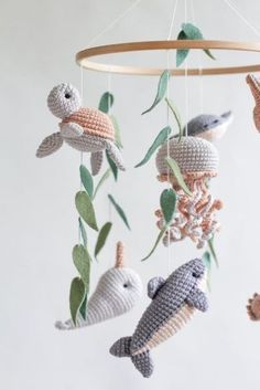 a crocheted mobile with sea animals hanging from it's sides and leaves