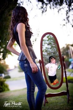 a woman standing in front of a mirror