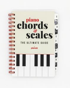 the ultimate guide to piano chords and scales for beginners, with an open spiral notebook