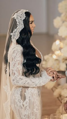 the bride and groom are exchanging their wedding rings at the altar in front of a decorated christmas tree