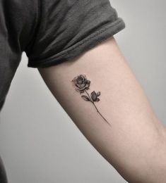 a single rose tattoo on the left arm