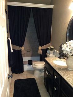 the bathroom is decorated in black and white