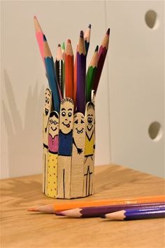 pencils and markers in a cup on a table