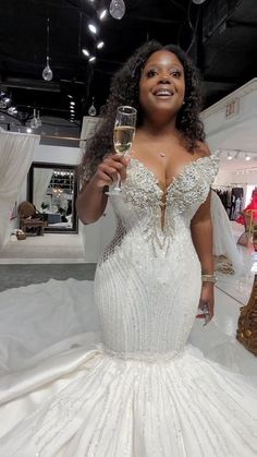 a woman in a wedding dress holding a glass of wine