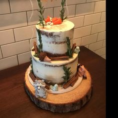 a three tiered cake sitting on top of a wooden table