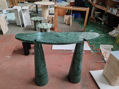 a green marble table sitting on top of a floor