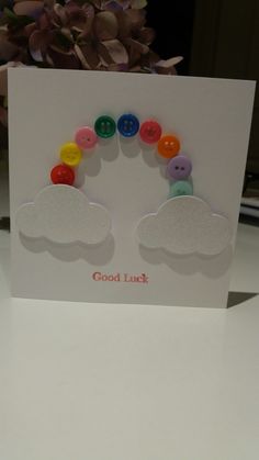 a card with buttons and clouds on it