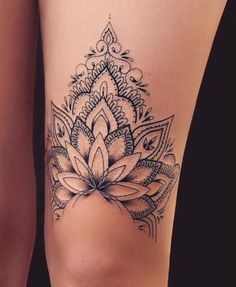 a woman's thigh with a flower tattoo on it