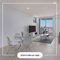 a living room filled with furniture and a flat screen tv sitting on top of a table