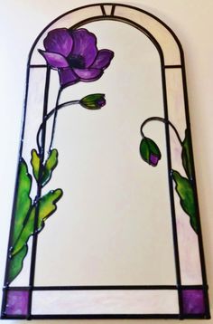 a stained glass window with purple flowers on it