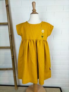 This short-sleeved dress in medium-weight pure linen is embellished with hand-made floral embroidery, the high front yoke is lined and finished with a bias of floral cotton fabric, made in 3 years, it is This is a unique, handmade piece. Details: - Yellow color - Composition: 100% Oeko-Tex certified linen - 2 buttons in the back - Medium weight flax - Care: wash at 30o, medium spin, air dry or tumble dry at low temperature, medium iron Fitted Embroidered Linen Dress For Summer, Fitted Linen Embroidered Dress For Summer, Fitted Linen Embroidered Summer Dress, Spring Cotton Fitted Short Sleeve Dress, Fitted Cotton Short Sleeve Dress For Spring, Fitted Short Sleeve Cotton Dress For Spring, Fitted Cotton Dresses With Floral Applique, Fitted Linen Dress With Floral Embroidery For Summer, Yellow Linen Short Sleeve Dress For Summer