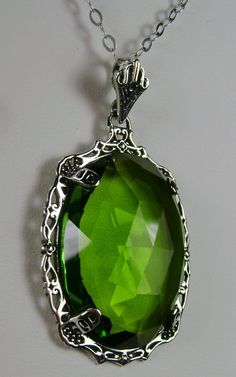 "Simulated Green Peridot Pendant Bubble Design#P10 Custom Made Inspired by Victorian era designs, I now offer this lovely Antique reproduction in sterling silver. The flawless simulated/man-made 22ct faceted green peridot gemstone is 24mm long (15/16th\") and 18mm in width (3/4th\"). The entire pendant is 1.5\" long and 7/8\" wide. The chain (if chosen) is between 18-20 inches in length and is marked 925 as well. Notice the beautiful craftsmanship of the Victorian filigree setting. This pendant Ornate Green Jewelry With Jewels, Victorian Green Jewelry With Jewels, Ornate Green Jewelry For Formal Occasions, Victorian Green Jeweled Jewelry, Green Victorian Necklace For Wedding, Ornate Green Necklace With Intricate Design, Ornate Green Jewelry For May Birthstone, Green Jewelry With Intricate Design For Gift, Ornate Green May Birthstone Jewelry