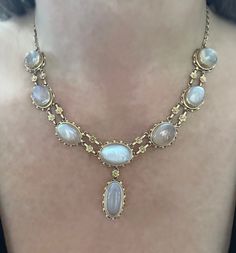 Incredibly rare antique necklace in 14k solid gold with 8 top quality rainbow moonstones. Necklace consists of bezel set moonstones connected with floral links.  It appears hand fabricated displaying superb quality throughout.  Moonstones are estimated to weight approximately 70 carats, they have amazing blue iridescence and are totally eye clean. Stones like this wholesale for over $150 a carat and to find a matching set like this is nearly impossible.   Secure latch,  Total weight is 32.76 gra Vintage Moonstone Necklace, Rainbow Moonstone Necklace, Bib Necklaces, 14k Gold Necklace, Antique Necklace, Moonstone Necklace, Moonstone Jewelry, Jewel Box, Moon Stone