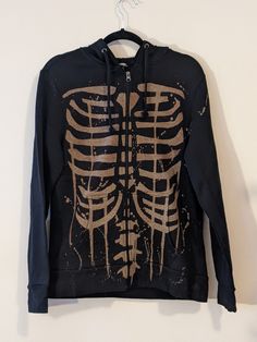 Here we have a black zip hoodie with my skeleton design bleached on the front and back. This cozy gothic hoodie allows you to stay both warm and cool at the same time (if you know what I mean). Sizes range from a men's S-2XL. A sizing chart has been included.  READ THIS BEFORE ORDERING: Takes 1 week to ship out. If you need it by a certain time let me know and I will do my best. Brands used for base include Gildan, ATC, George, and Alstyle Poly cotton blend Feel free to let me know if you requir Edgy Skull Print Hoodie For Halloween, Grunge Skull Print Hoodie For Fall, Black Skull Hoodie For Fall, Acid Wash Grunge Hoodie For Fall, Bleach Skeleton, Bleach Hoodie, Egirl Fashion, Black Zip Hoodie, Hoodie Diy