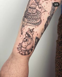 a person with a black and white tattoo on their arm that has an image of a cat in a hot air balloon