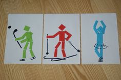 three different colored paper cutouts depicting skiers