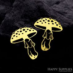 two yellow mushrooms with black dots on them are sitting next to each other in front of some rocks