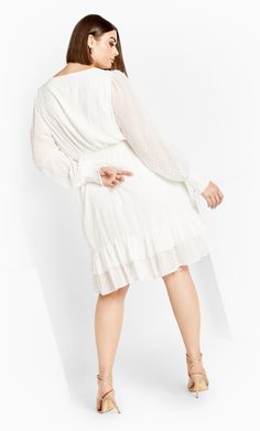 The Lea Dress exudes a timeless elegance and delicate charm! Featuring a front ruffle, mini length and sheer sleeves, anticipate compliments when you strut in this dress. Key Features Include: - V-neckline - Lace and button front detail - Sheer sleeves with elastic cuffs - Front ruffle - Mini length - All-over dobby detailing - Lined Style with gold jewelry for effortless glam! | Plus Size Lea Dress in Cream, Size 22 | City Chic Explore City, Denim Short Dresses, Exclusive Dress, Overall Dress, Cream Dress, Fit N Flare Dress, Sheer Sleeves, City Chic, Plus Size Dress