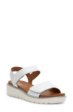 A lightweight platform wedge elevates this sporty sandal featuring a cushy, arch-supporting footbed and wide, adjustable leather straps for all-day comfort. Flat sole Removable, cushioned insole with arch support Leather upper and lining/synthetic sole Imported White Sporty Sandals With Arch Support, Platform Synthetic Slingback Sport Sandals, Synthetic Slingback Platform Sport Sandals, Modern White Sandals With Ortholite Insole, White Leather Slingback Wedge Sandals, Modern Ankle Strap Sport Sandals In Synthetic, Modern White Sport Sandals With Round Toe, Modern White Open Toe Sport Sandals, Modern Synthetic Sport Sandals With Ankle Strap