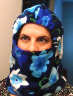 a woman wearing a blue flowered scarf around her head