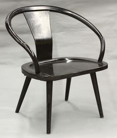 a black chair sitting on top of a white floor