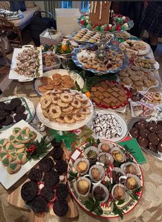 a table full of desserts and pastries on display for people to eat at