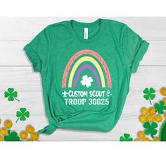 a green t - shirt that says custom scout troop with a rainbow and shamrocks