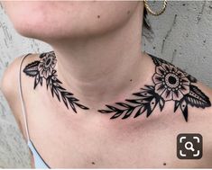 a woman with a black and white flower tattoo on her chest