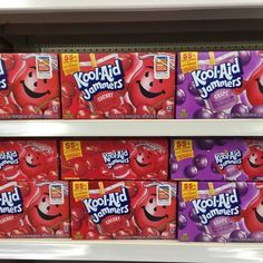 several boxes of kool aid gummies are on display in a grocery store aisle